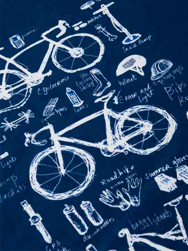 Cycling apparel design with bike sketches and gear labels on navy fabric