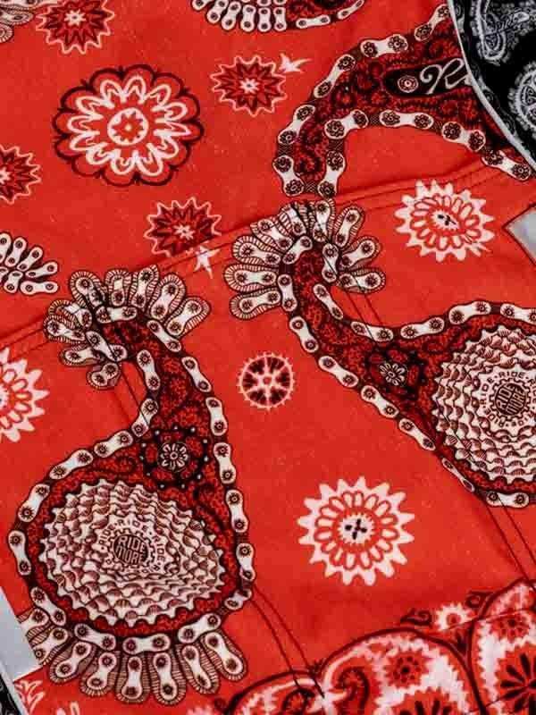 Red cycling jersey with intricate paisley and floral patterns in black and white