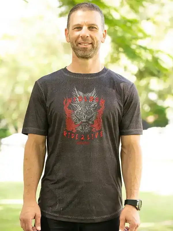 Man wearing dark cycling t-shirt with bold graphic design, ideal for bike rides and outdoor adventures.