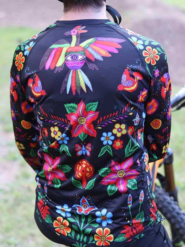 Vibrant floral and bird patterned cycling jersey for men, featuring bold colors and unique design on black fabric.