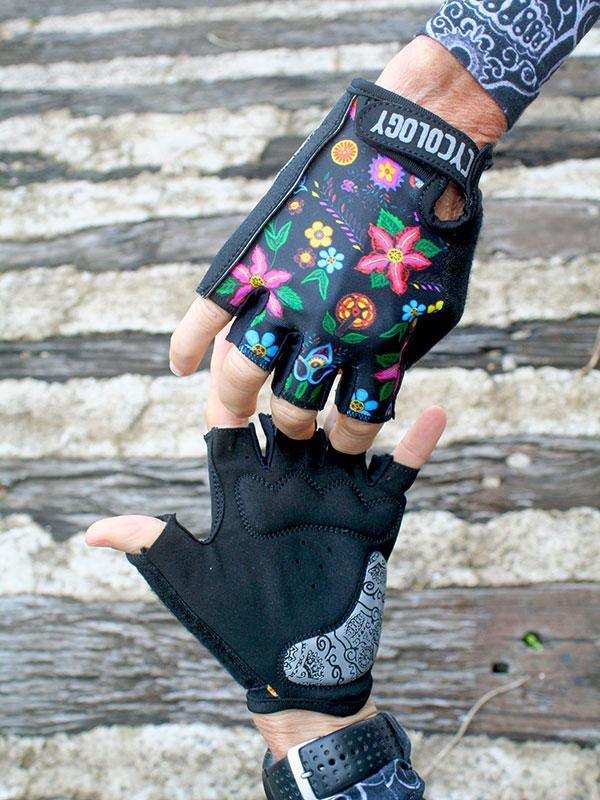 Colorful floral cycling gloves with black base, fingerless design, and patterned wrist strap for comfort and style.