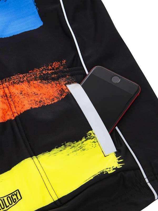 Black cycling shorts with bold yellow, orange, blue brushstroke design and rear pocket holding phone