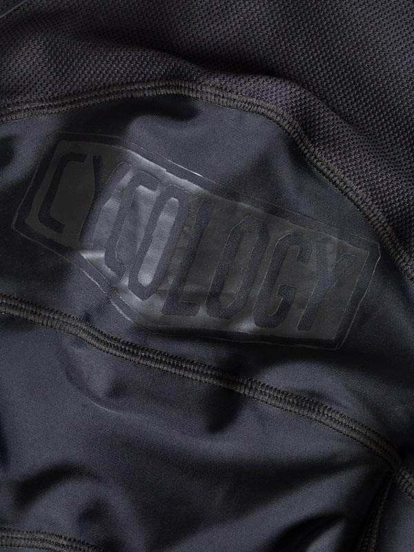 Black cycling jersey with subtle 'CYCOLOGY' logo, high-quality fabric detail for men's and women's rides
