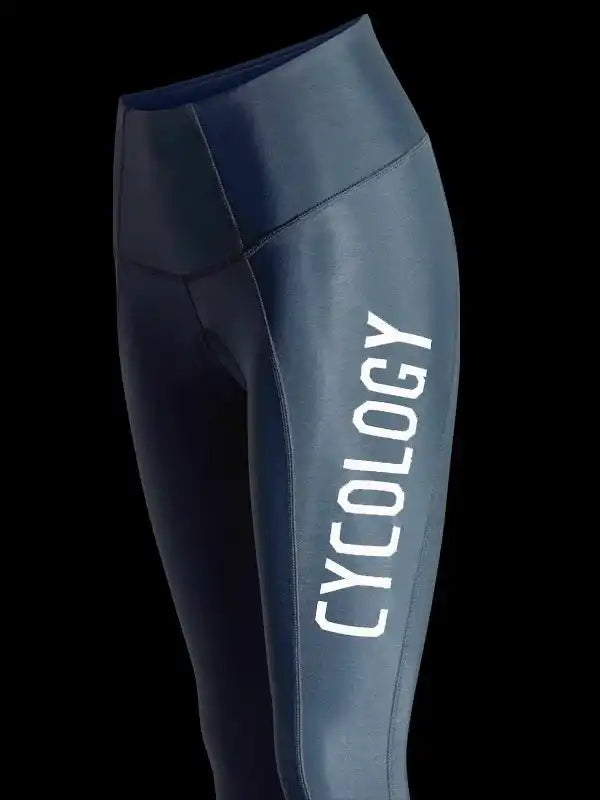 Dark blue cycling leggings with 'CYCOLOGY' white side print, high-waisted design for women's bike wear