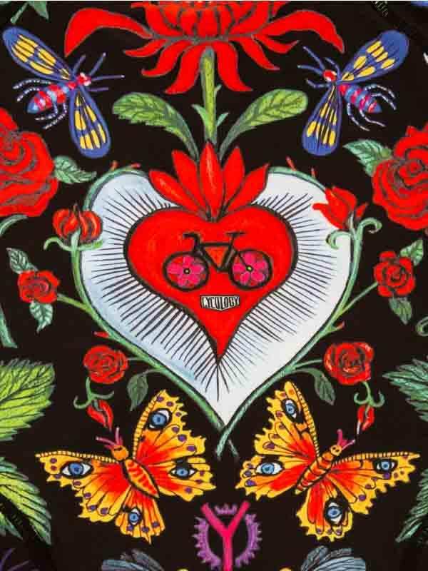 Vibrant cycling-themed print with heart, bike, roses, and butterflies on dark fabric