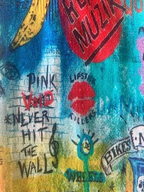 Colorful graffiti-style cycling jersey with bold text, lips, banana, and music notes design