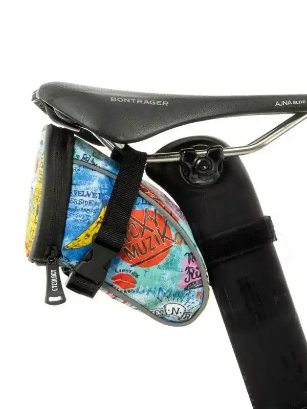 Colorful cycling saddle bag with music print attached to Bontrager bike seat, ideal for road or mountain biking gear storage.