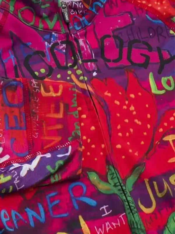 Vibrant graffiti-style cycling jersey with bold text and red tulip print, featuring front zipper and pocket.