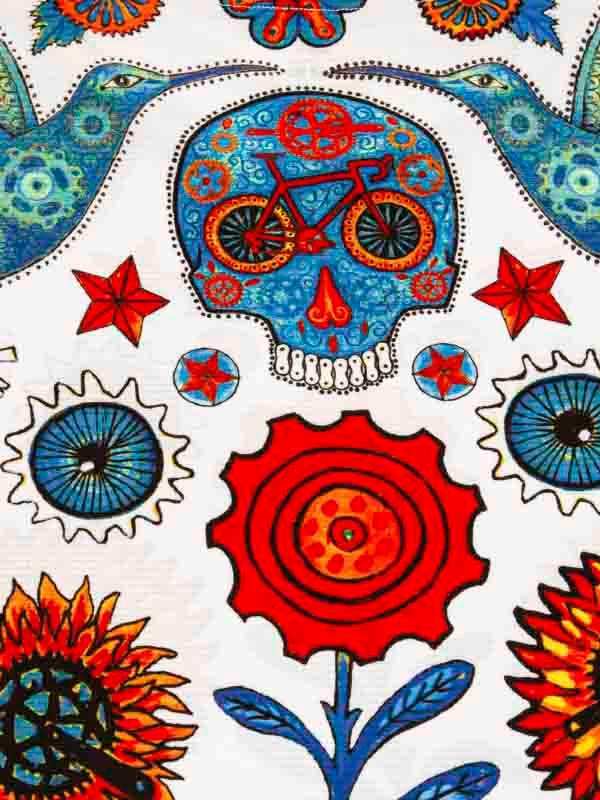 Vibrant cycling-themed fabric with skull, bike, flowers, and gears in bold blue and red