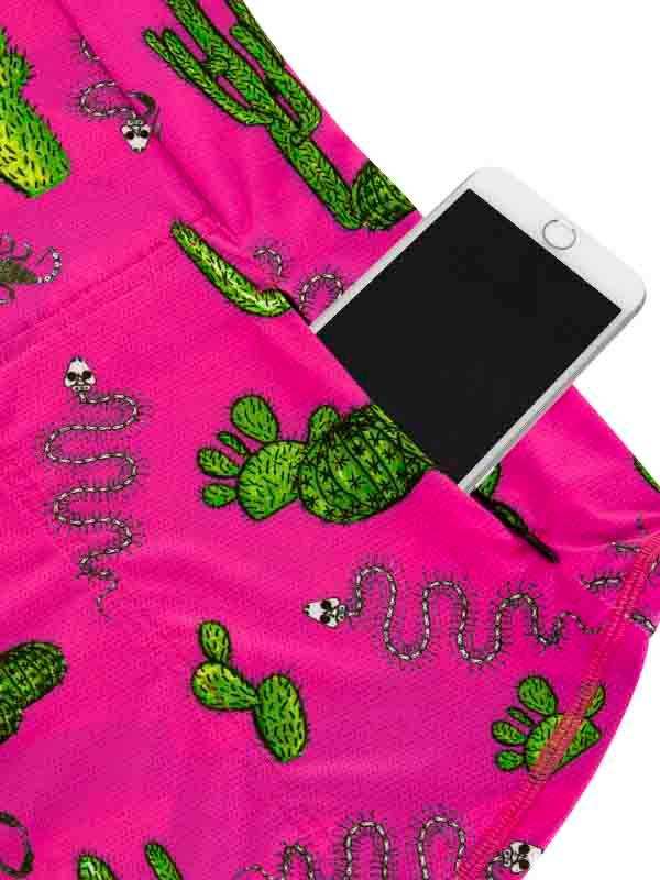 Pink cycling shorts with green cactus and snake print, phone in pocket