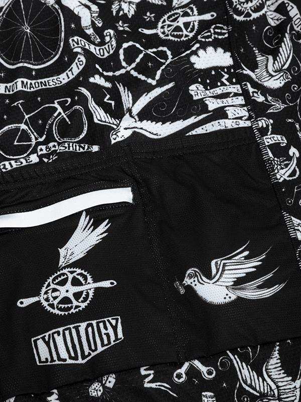 Black cycling shorts with white tattoo-style graphics, birds, gears, and 'CYCOLOGY' logo