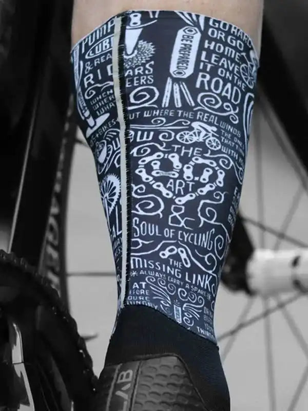 Cycling leg warmers with bold typography and bike graphics, perfect for road rides and cycling gear enthusiasts.