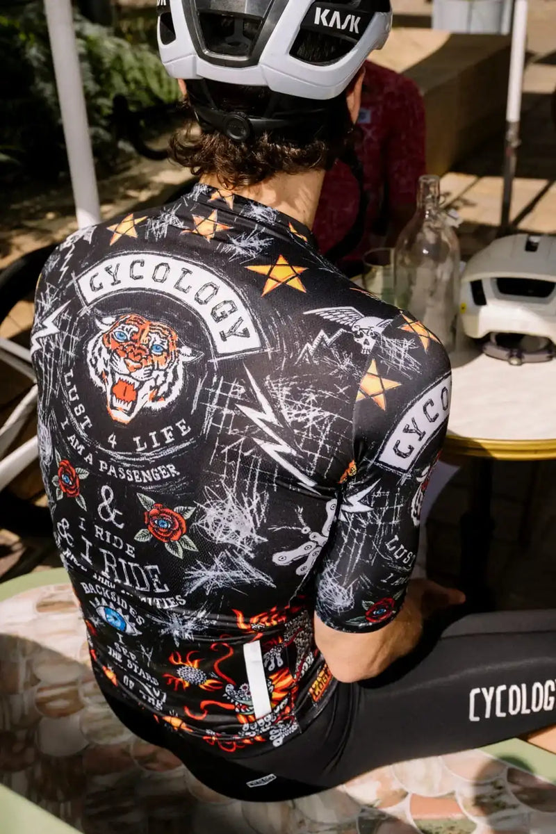 Men's cycling jersey with bold tiger graphic, stars, and tattoo-style designs for road biking