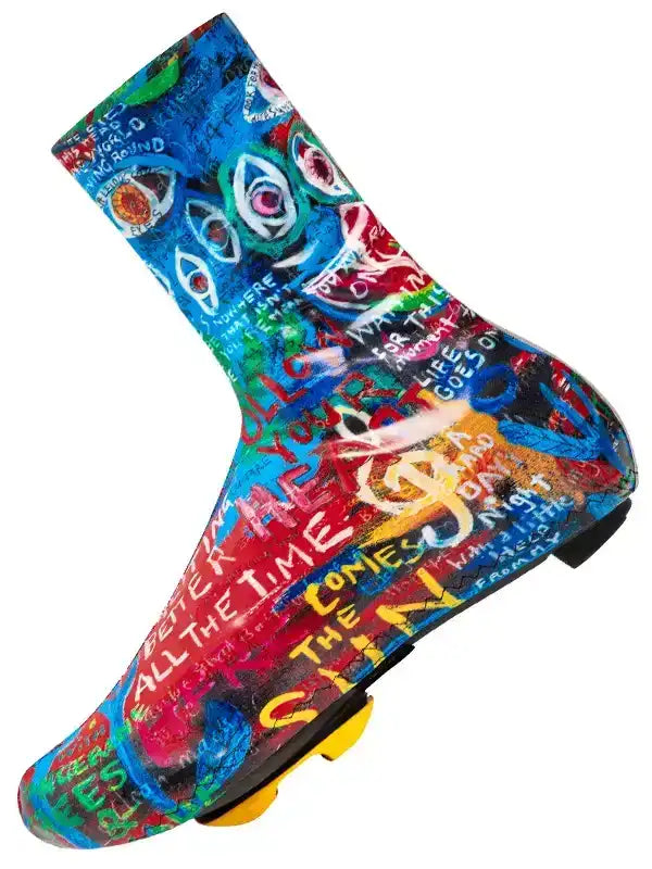 Colorful graffiti-style cycling shoe cover with bold text and eye graphics for road bike riders