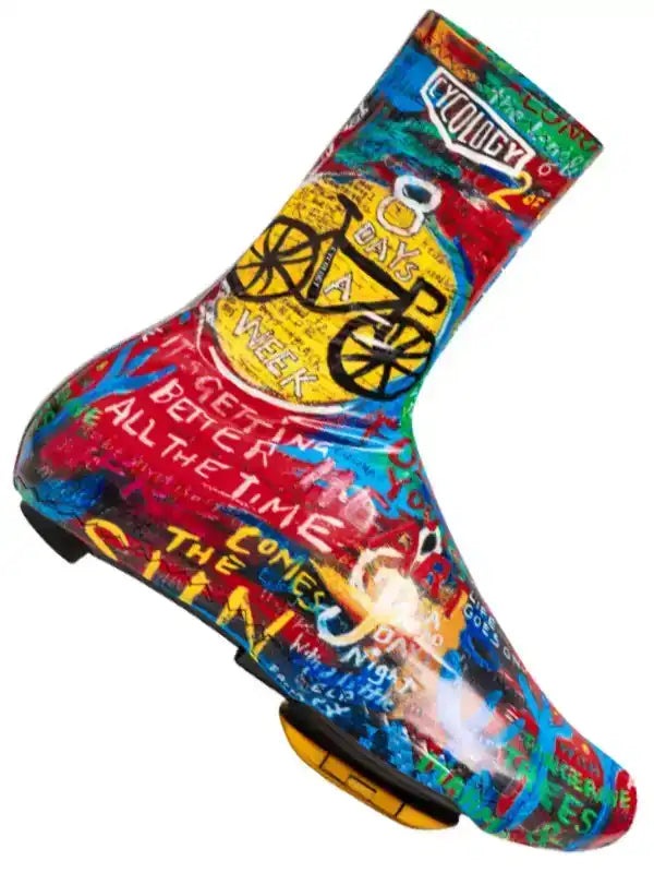Colorful cycling shoe cover with graffiti art, bike graphics, and motivational text for road riders