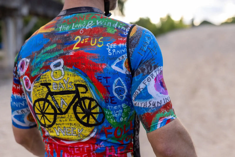 Colorful men's cycling jersey with bold graphics, bike print, and motivational text, perfect for road rides.