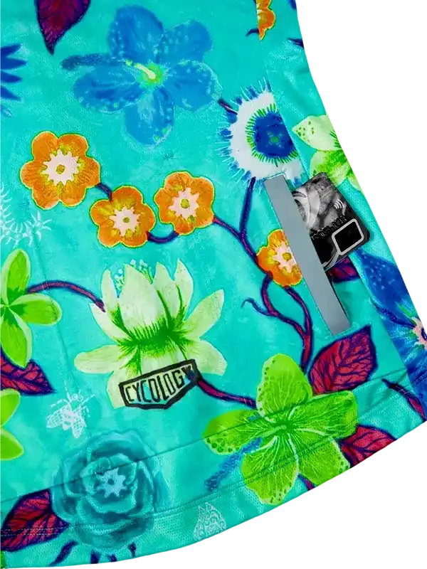 Vibrant floral cycling jersey with turquoise base, orange and green blooms, and reflective strip for safety
