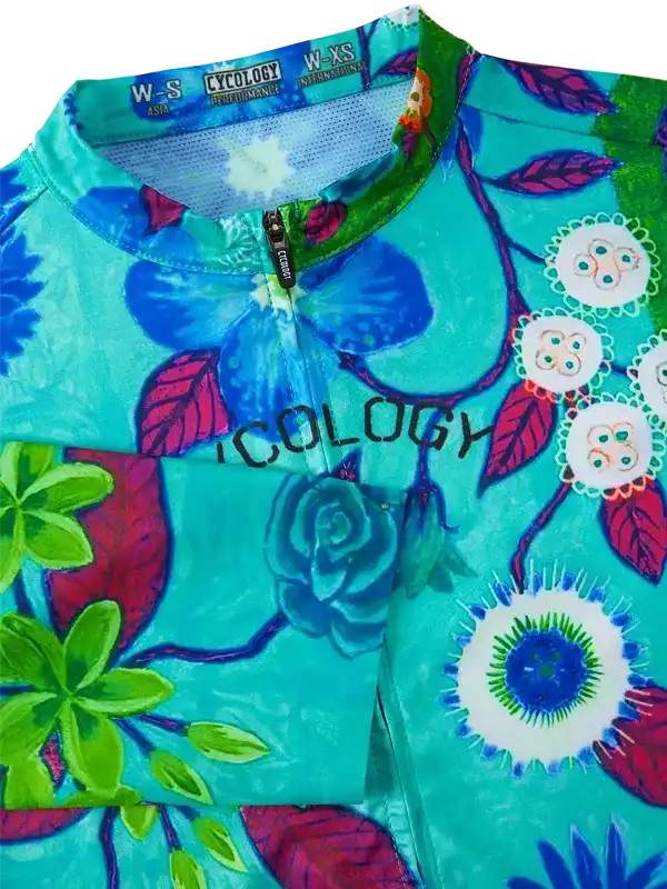 Vibrant floral cycling jersey with blue, green, and pink botanical print, featuring zipper and performance fabric.