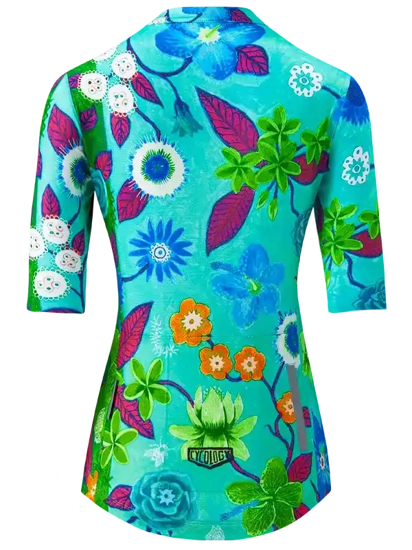 Women's cycling jersey with vibrant floral print, turquoise base, 3/4 sleeves, and reflective details for safety.
