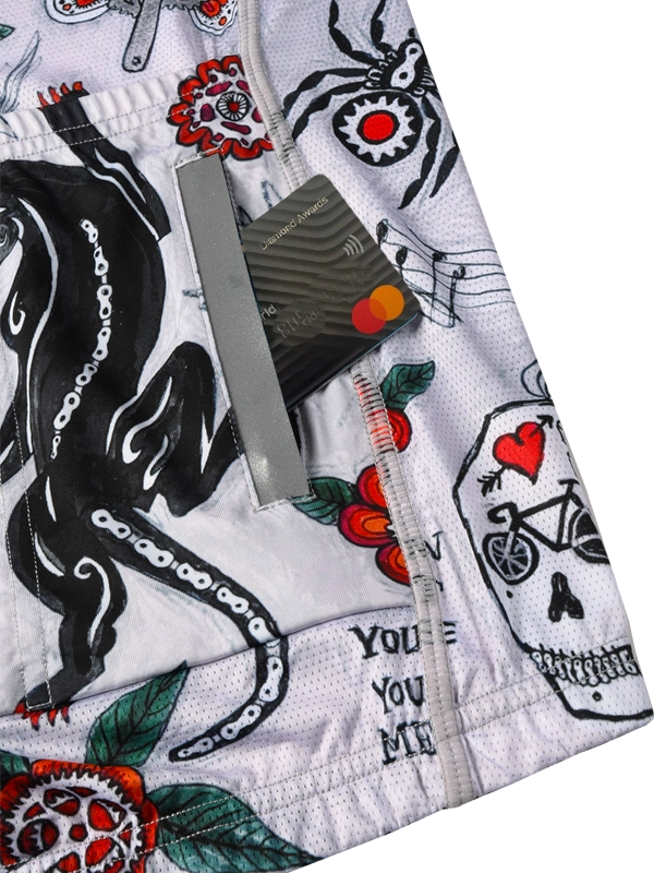 Close-up of a patterned fabric with tattoos, flowers, and text on a white background.