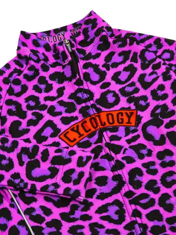 Vibrant pink and purple leopard print cycling jersey with bold 'CYCOLOGY' logo, perfect for women's cycling apparel.