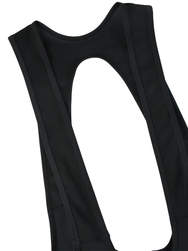 Close-up of  black bib-style cycling  bibs showing wide shoulder straps and a large cutout opening on a plain white background.
