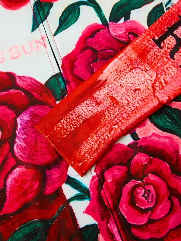 Red fabric with floral pattern in the background