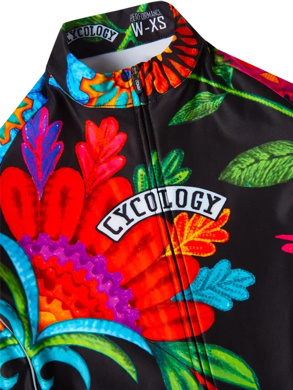 Vibrant floral cycling jersey with bold colors and 'Cycology' logo, designed for performance and style.