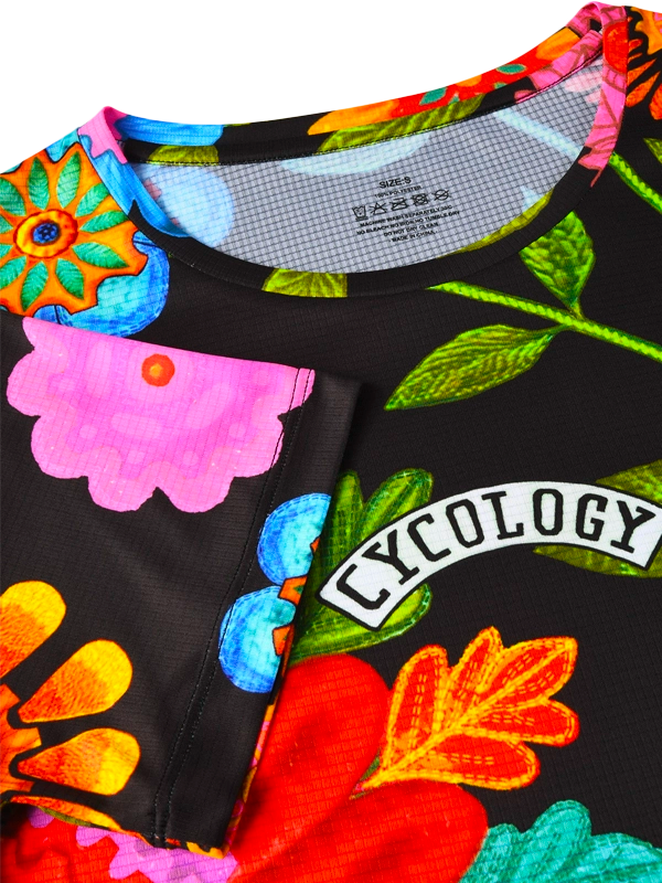 Colorful floral-patterned tech tee with 'Cycology' branding on a black background