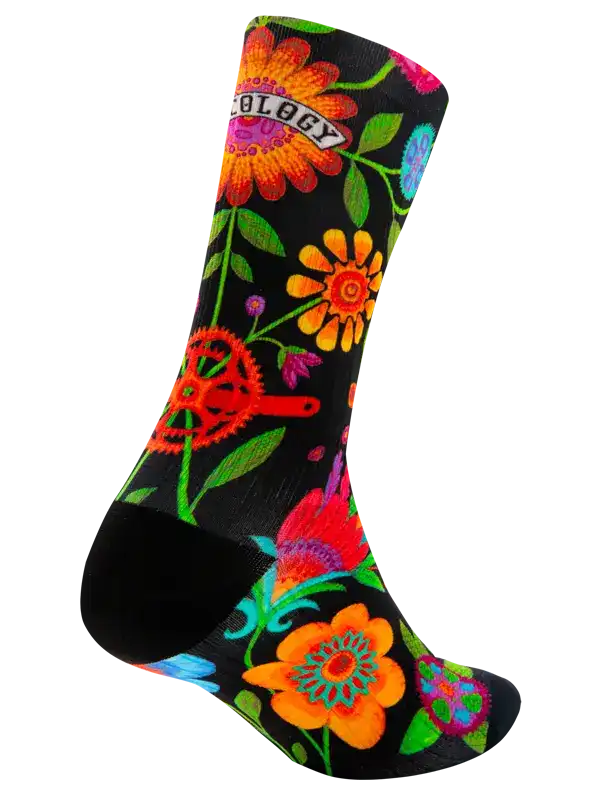 Vibrant floral and gear print cycling sock with black base, perfect for bike rides and outdoor adventures.