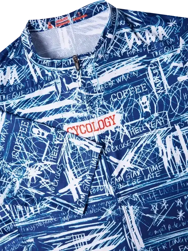 Blue cycling jersey with white graffiti-style graphics and 'CYCOLOGY' logo, featuring motivational phrases and zipper detail.