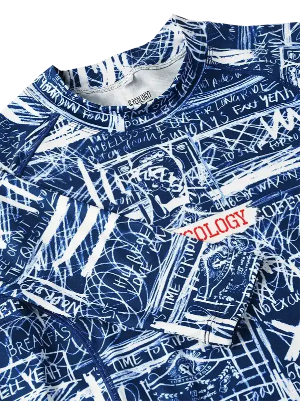 Blue cycling jersey with white graffiti-style graphics and 'OLOGY' text, featuring bold patterns and cycling-themed phrases.