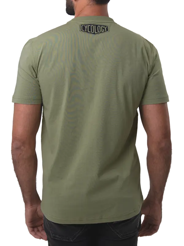 Person wearing a green t-shirt with 'Cycology' logo on the back, 