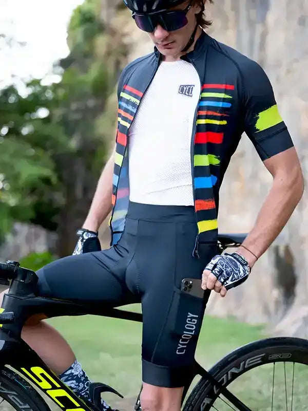 Men's cycling jersey and shorts with colorful stripe design, worn by cyclist on road bike outdoors