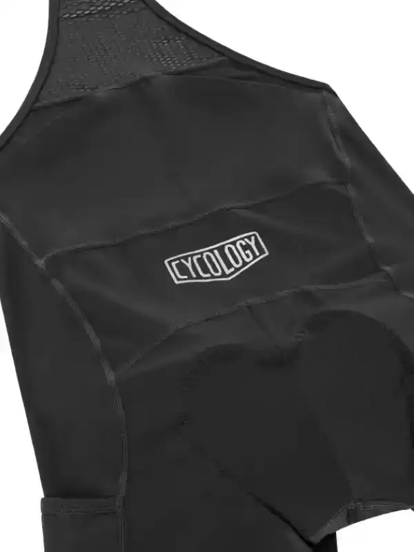 Black women's cycling bib shorts with CYCOLOGY logo, padded seat, and mesh back panel