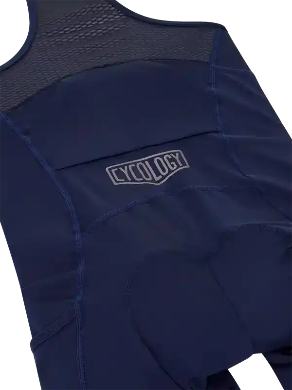 Navy blue cycling bib shorts with mesh back panel and CYCOLOGY logo, designed for comfort and performance.