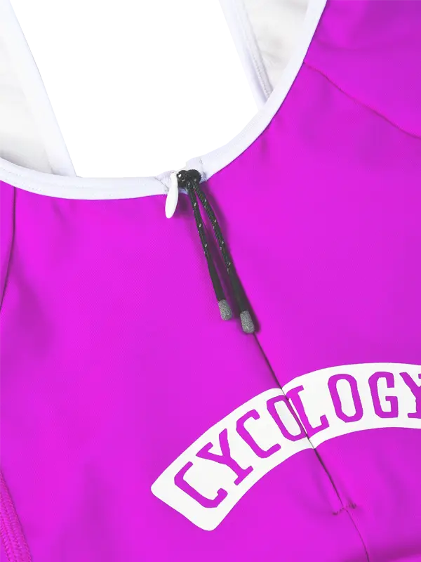 Close-up of a bright pink quick pee cycling bibs zipper at the rear with a white arched 'CYCOLOGY' logo patch on the back, 