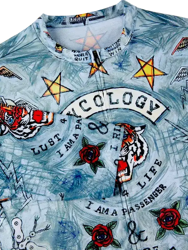 Men's cycling jersey with tiger, roses, stars, and 'I AM A PASSENGER' tattoo-style graphics on light blue fabric