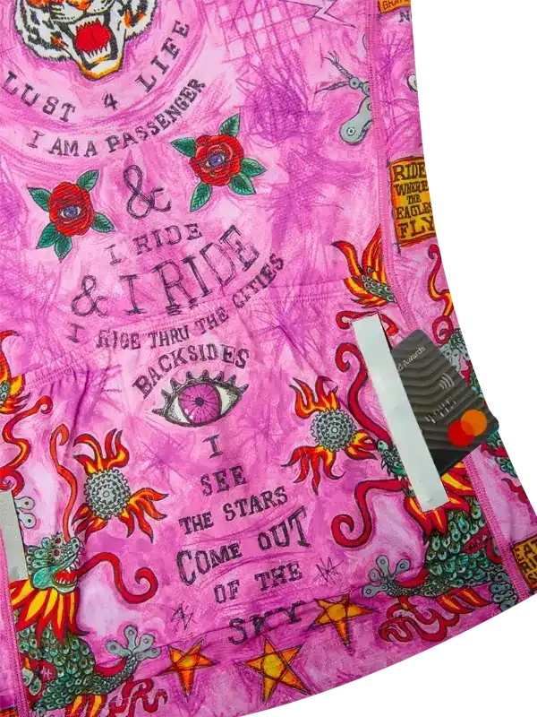 Pink cycling jersey with bold graphics, roses, dragons, and motivational phrases for riders.