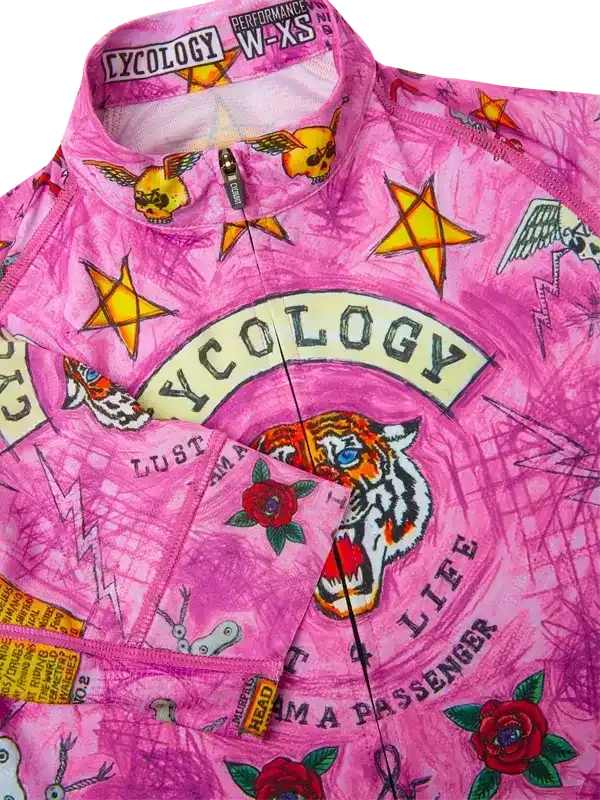 Pink cycling jersey with tiger, roses, stars, and tattoo-style graphics for women's road biking