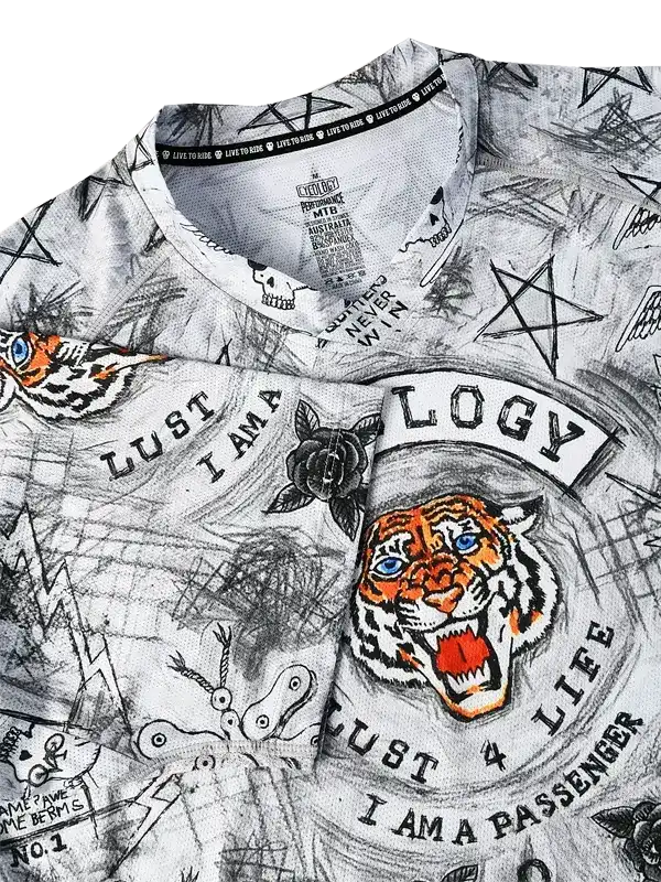 Men's cycling jersey with bold tiger graphic, skull, and tattoo-style designs on white fabric