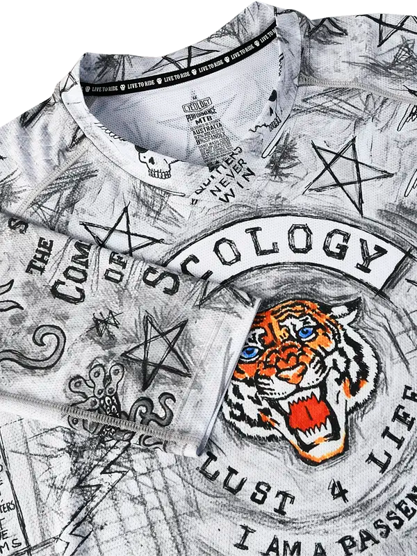 Close-up of a MTB  V Neck shirt with graphic designs and text, including a tiger and star symbols.