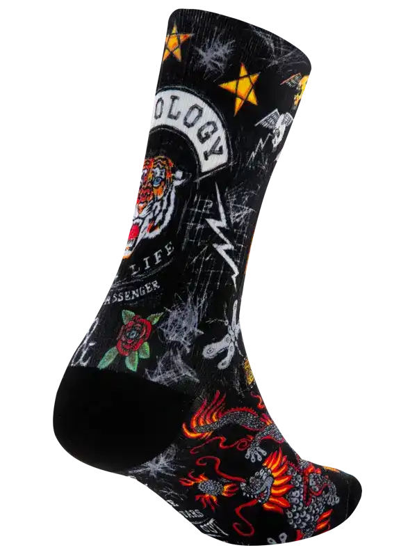Black cycling sock with bold tattoo-style graphics including tiger, dragon, rose, and stars for men's and women's rides