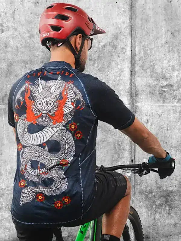 Men's cycling jersey with dragon graphic, worn while riding bike, featuring bold design and breathable fabric