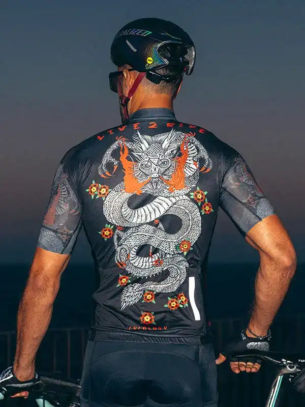 Men's cycling jersey with dragon graphic, floral accents, and 'LIVE2RIDE' text, worn with helmet and bike gear