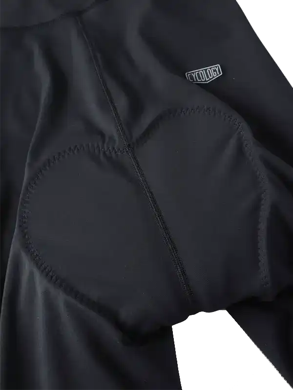 Black cycling bib shorts with padded chamois and Cycology logo, designed for comfort and performance.