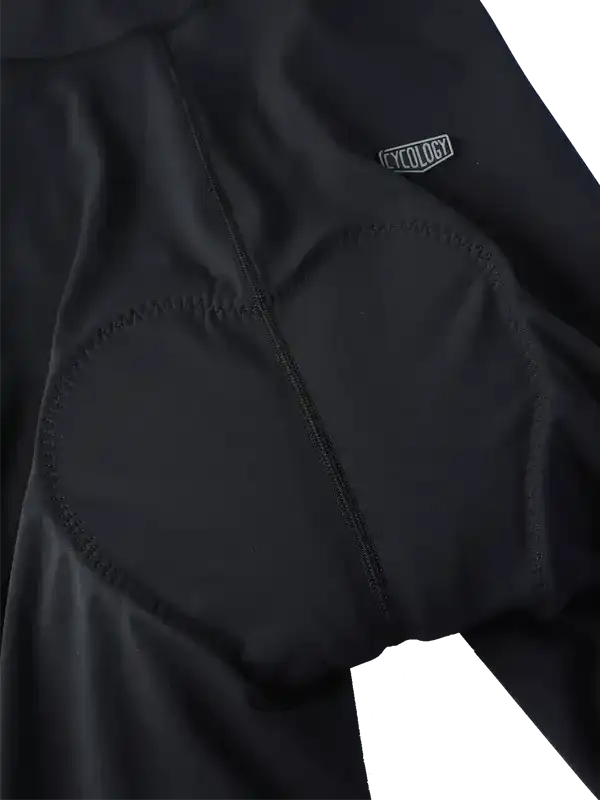Black cycling shorts with padded seat and Cycology logo, designed for comfort and performance.