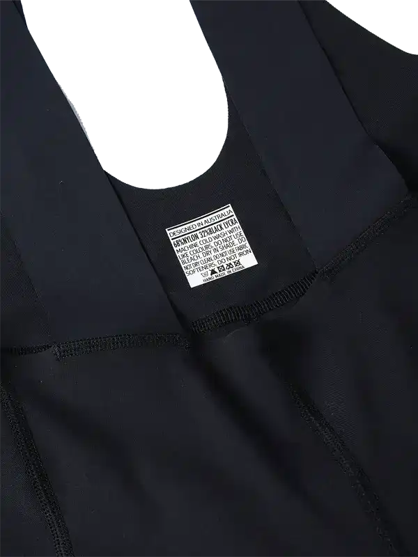 Black cycling bib shorts with care label, designed in Australia, high-quality fabric for men and women