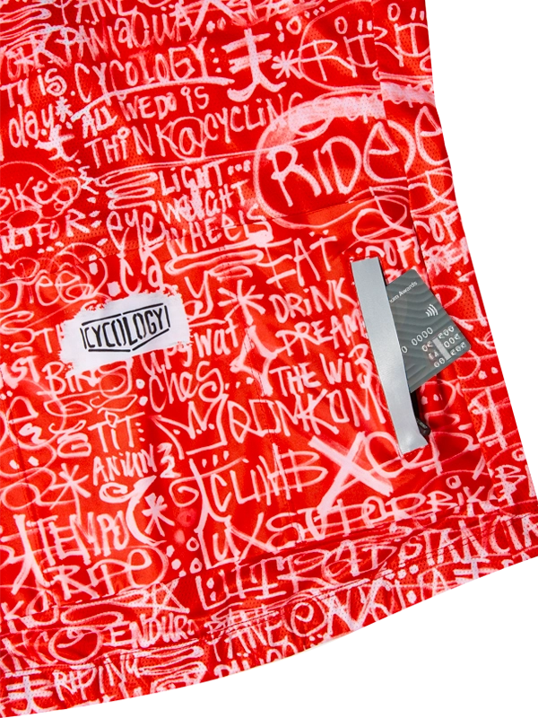 Red cycling jersey with white text pattern back pockets