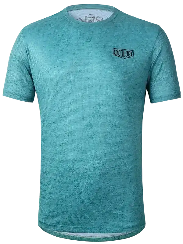 Teal men's cycling jersey with textured fabric and small chest logo, designed for comfort and performance.